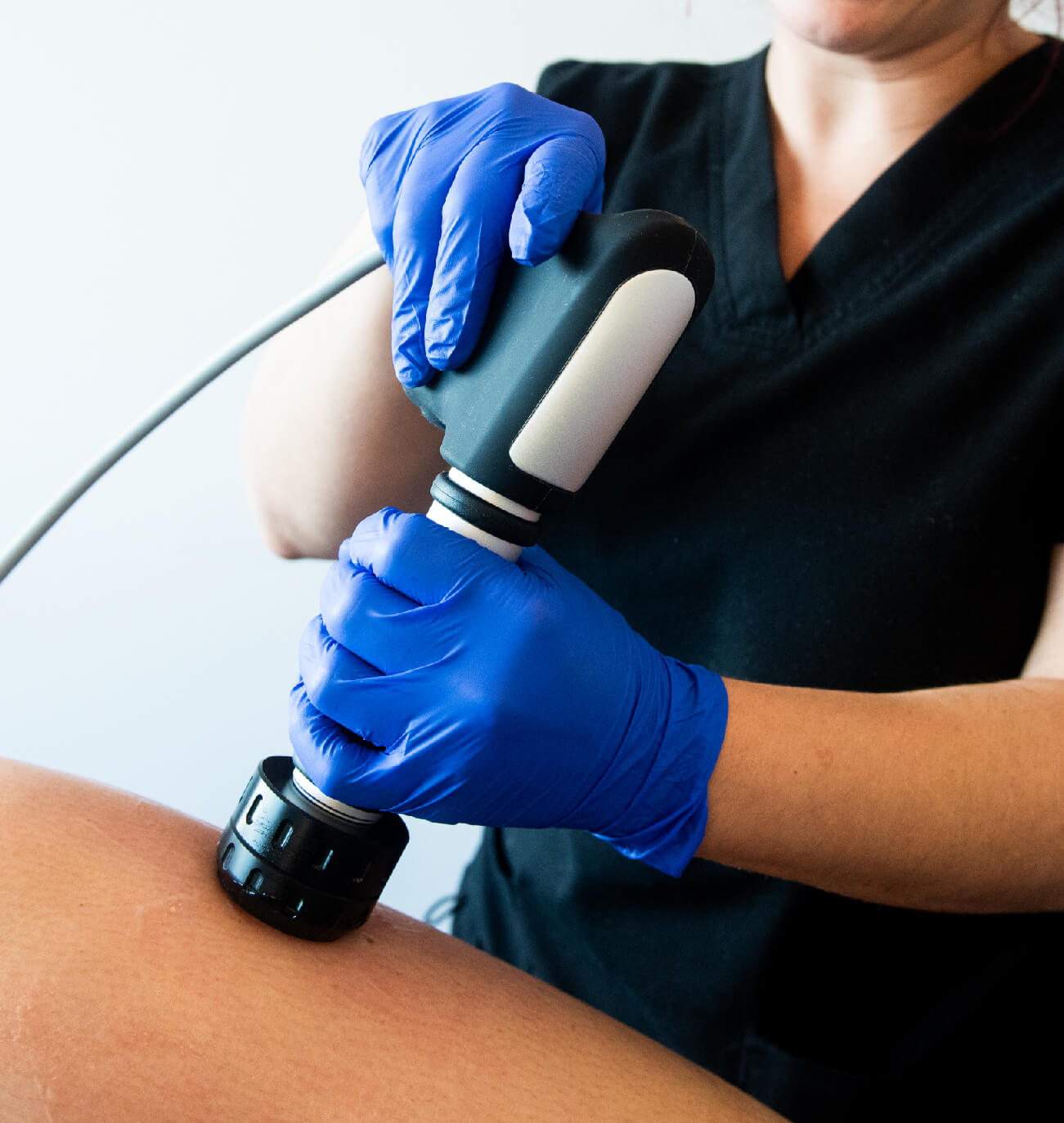 Application du traitement CelluSkin par un professionnel : utilisation d’un appareil à ondes de choc sur la peau pour stimuler la circulation, raffermir les tissus et réduire la cellulite. Une technologie avancée pour une peau plus lisse et tonifiée.